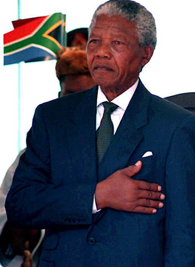 South African President Nelson Mandela stands at a